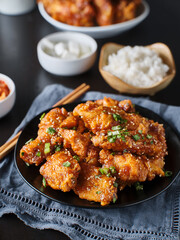 crispy fried korean chicken wings in galbi sauce with pickled radish, kimchi, and rice side dishes