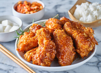 crispy fried korean chicken wings in soy garlic sauce with pickled radish and kimchi sides