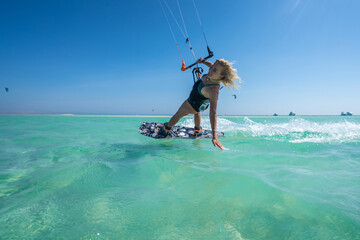 Kite girl rides in the ocean clear water