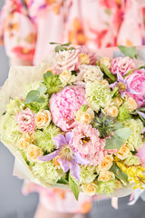 Beautiful bouquet of mixed flowers in woman hand. Floral shop concept . Handsome fresh bouquet. Flowers delivery.