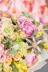 Beautiful bouquet of mixed flowers in woman hand. Floral shop concept . Handsome fresh bouquet. Flowers delivery.