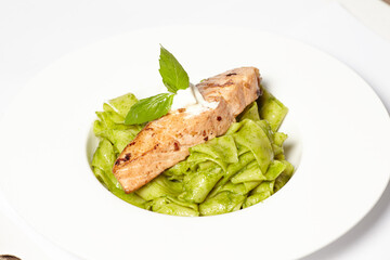 Salmon steak with pasta and fresh basil