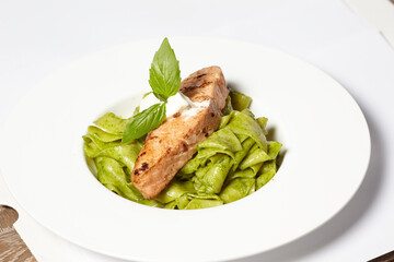 Salmon steak with pasta and fresh basil
