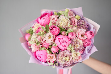 Beautiful bouquet of mixed flowers in woman hand. Floral shop concept . Handsome fresh bouquet. Flowers delivery.