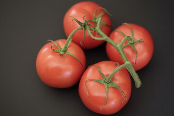 red tomatoes on a black background 