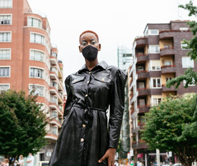 Beautiful black girl model with mask on the street