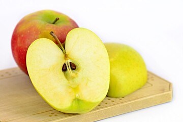 Red apple on a wooden board. Red apple isolated on white background.