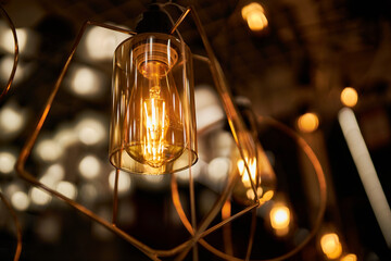 Edison loft style lamp with bokeh light background. Edison lamp, closeup photo. Edison lamp on...
