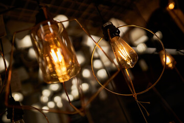 Edison loft style lamp with bokeh light background. Edison lamp, closeup photo. Edison lamp on...