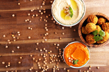 Traditional homemade hummus, falafel and chickpea on rustic table. Jewish Cuisine.
