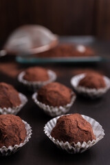 Homemade chocolate truffles on brown table