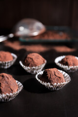 Homemade chocolate truffles on brown table