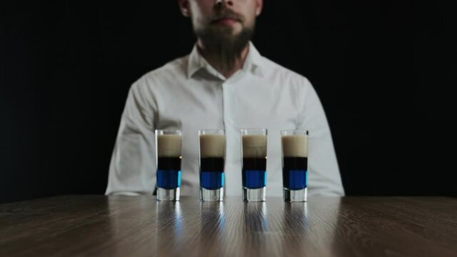 Set of several shot glasses with lexus cocktails. Ready for drinking. Zoom out