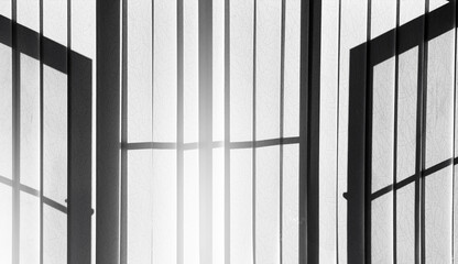 Shade and shadow on window blinds in retro filter, Morning sunlight shining through venetian blinds by the window. minimalismof line and light