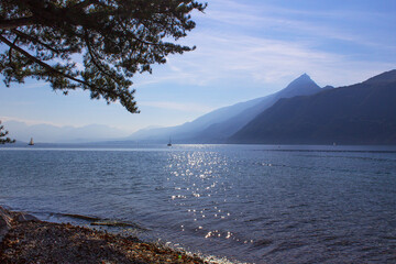 Beautiful summer peaceful landscape with blue water sky boats and mountains, relax and travel