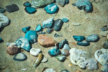 Multi-colored colorful sea pebbles, natural background, texture. Close-up texture of colorful sea pebbles. Sea background and beach