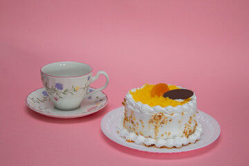 cake with cream icing, egg thread and a cup of tea