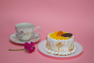 cake with cream icing, egg thread and a cup of tea