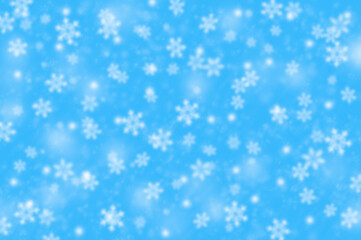 blurred winter snow blue background. falling snowflakes. merry christmas concept