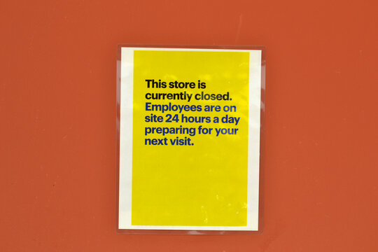 This Store Is Currently Closed - Employees Are On Site 24 Hours A Day Preparing For Your Next Visit - Yellow Signage