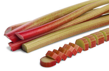 Pile of thick reddish stalks of rhubarb (rheum rhaponticum) without leaves and cut pieces isolated on white background.