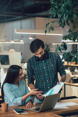 Clever young coworkers discussing their new project