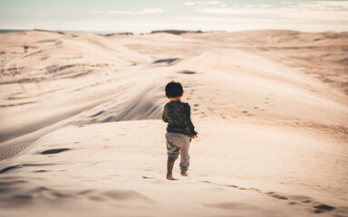 Fototapeta na wymiar Kid running in Lancelin Sand Dunes in Western Australia