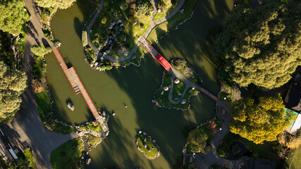An aerial top-down view on Japanese styled garden with oriental architecture accents with the green...