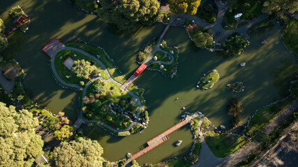 An aerial top-down view on Japanese styled garden with oriental architecture accents with the green...