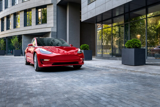 Kyiv, Ukraine - June 7, 2020: Red Tesla model 3 in city