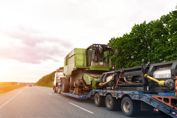 Heavy industrial truck with semi trailer platform transport disassembled combine harvester machine...