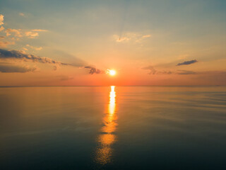 Aerial view of the sunset and reflections over the calm sea
