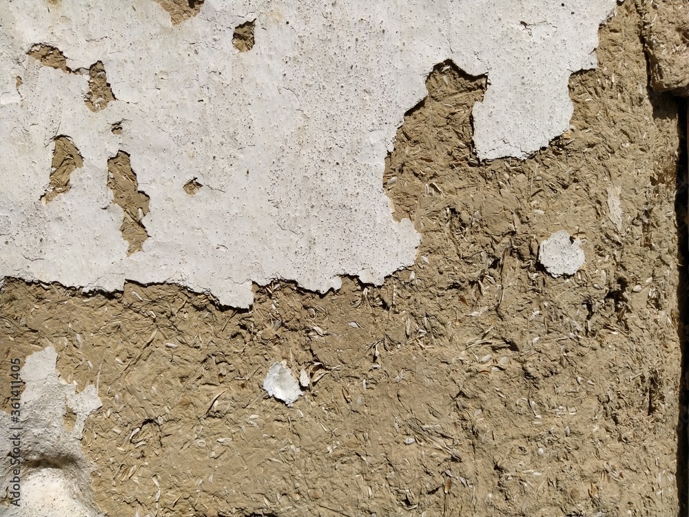 Poster close-up background of the wall of an old house made of clay mixed with straw. old type of construct