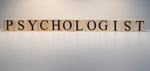 Psychologist text from wooden cubes. The term psychology profession.