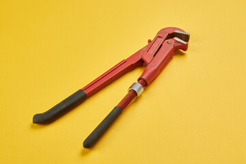 A monkey wrench on the yellow background. service concept.