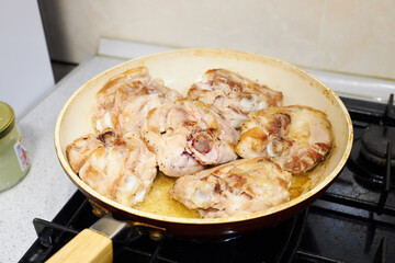 female cooking chicken meat for dinner. authentic life.