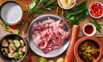 thai green chicken curry recipe with all assembled ingredients prepared on wooden table top