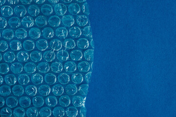 Packaging with air bubbles on a blue background. Bubble wrap texture, packaging, air bubble film....