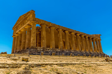 A close up view of the Temple of Concordia from the side in the ancient Sicilian city of Agrigento in summer
