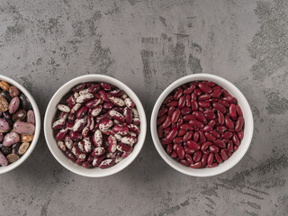 Three kinds of beans in round bowls. The view from the top.