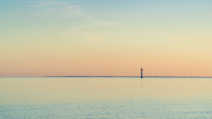 Fototapeta na wymiar Chauveau lighthouse, isle of Re, at sunset on a very calm sea.