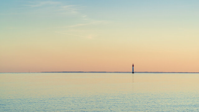 Chauveau lighthouse, isle of Re, at sunset on a very calm sea.