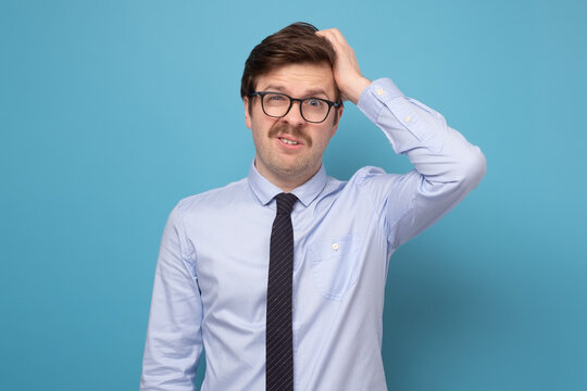 Young businessman puzzled trying to make a hard decision