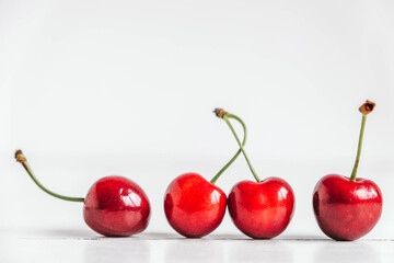 Fresh ripe cherries on the white wooden background. Copy, empty space for text