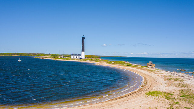 Saaremaa, Estonia - June 25, 2020 : Beautiful panoramic aerial view photo from flying drone over sunny Sorve lighthouse. The cylindrical concrete lighthouse in Saaremaa island Estonia (Series) 