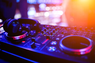 DJ remote controller in nightclub in perspective with professional headphones - obrazy, fototapety, plakaty