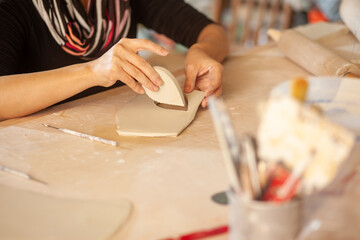 Obraz na płótnie Canvas female artist working with clay in their studio