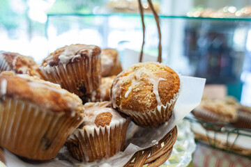 muffins for sale in a basket at a bakery
