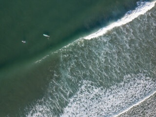 Fototapeta na wymiar Aerial photo of waves breaking near a rural surf beach, New Zealand. 