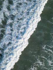 Aerial photo of waves breaking near a rural surf beach, New Zealand. 